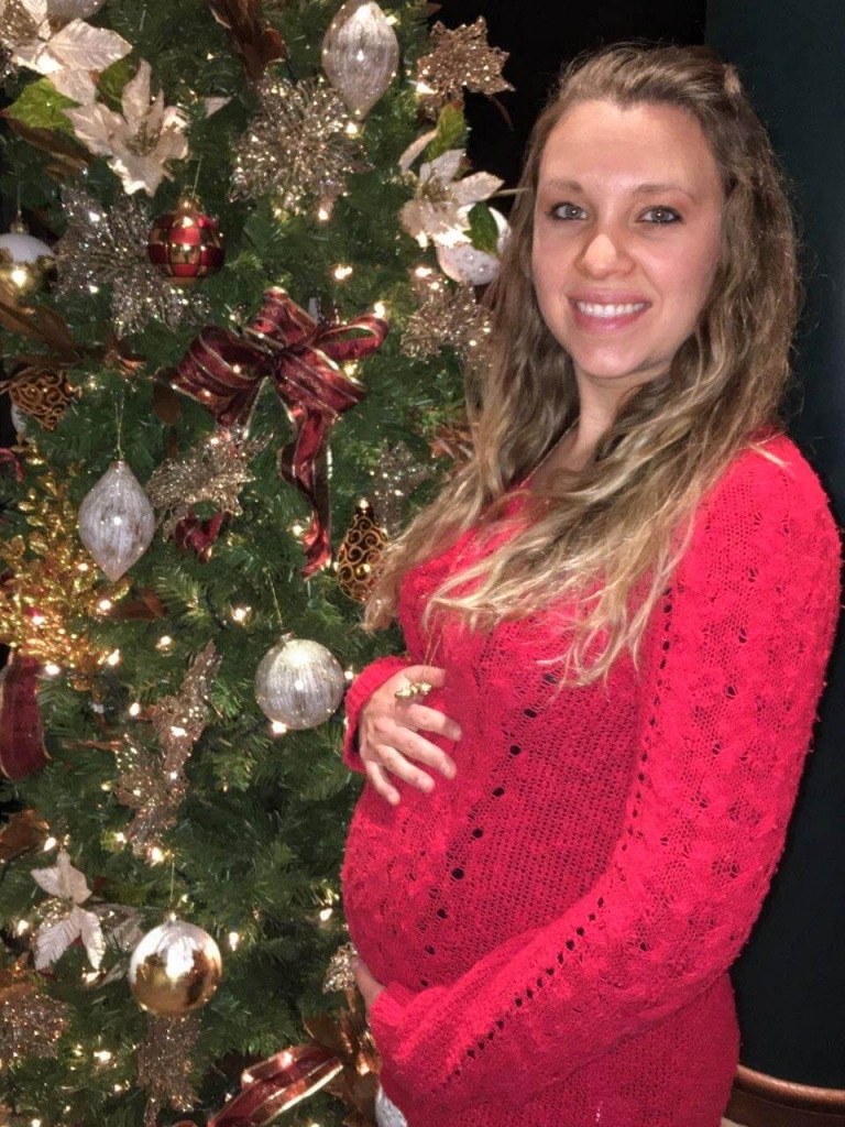 Pregnant lady by Christmas tree