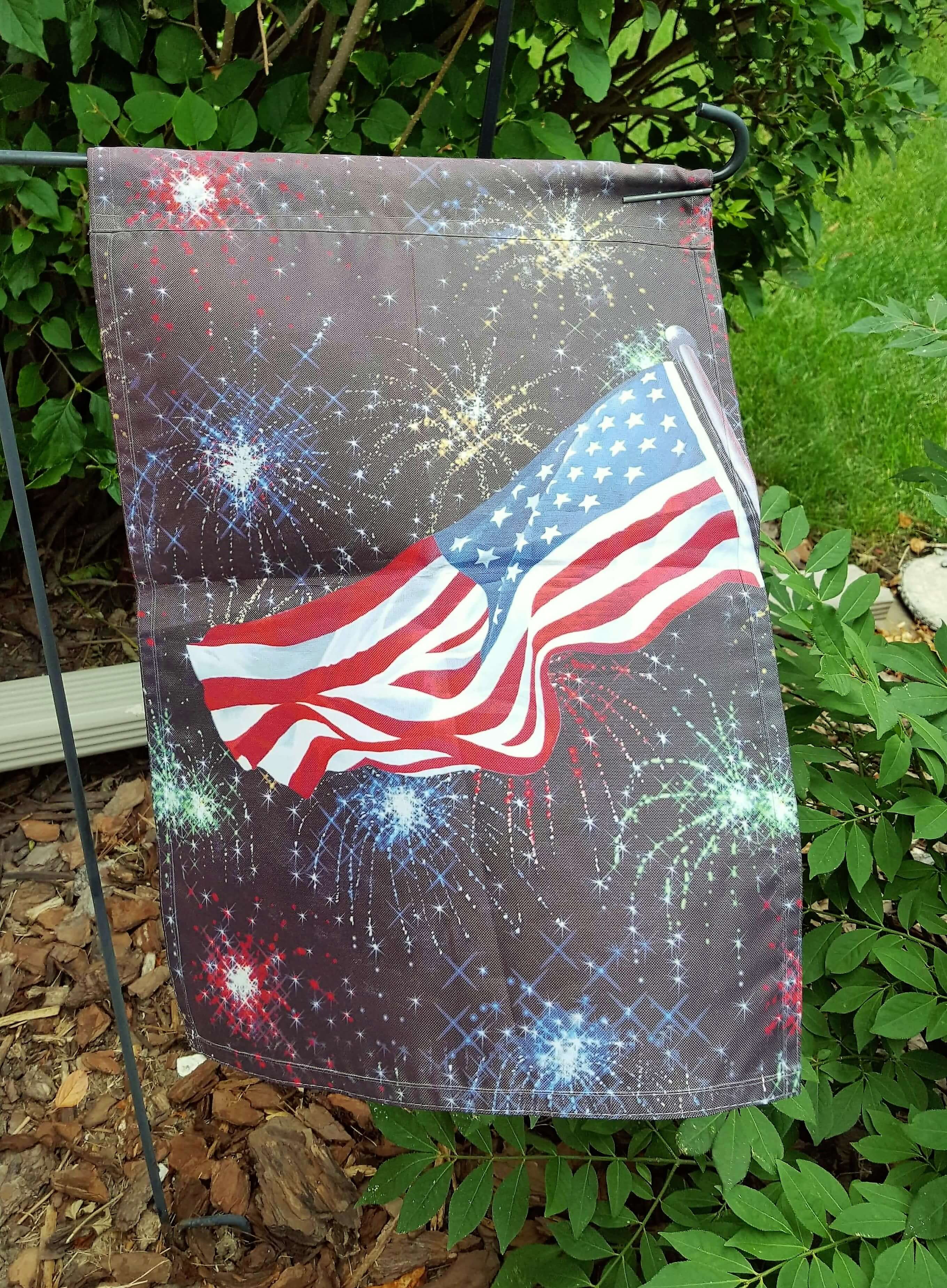 Fireworks behind flag