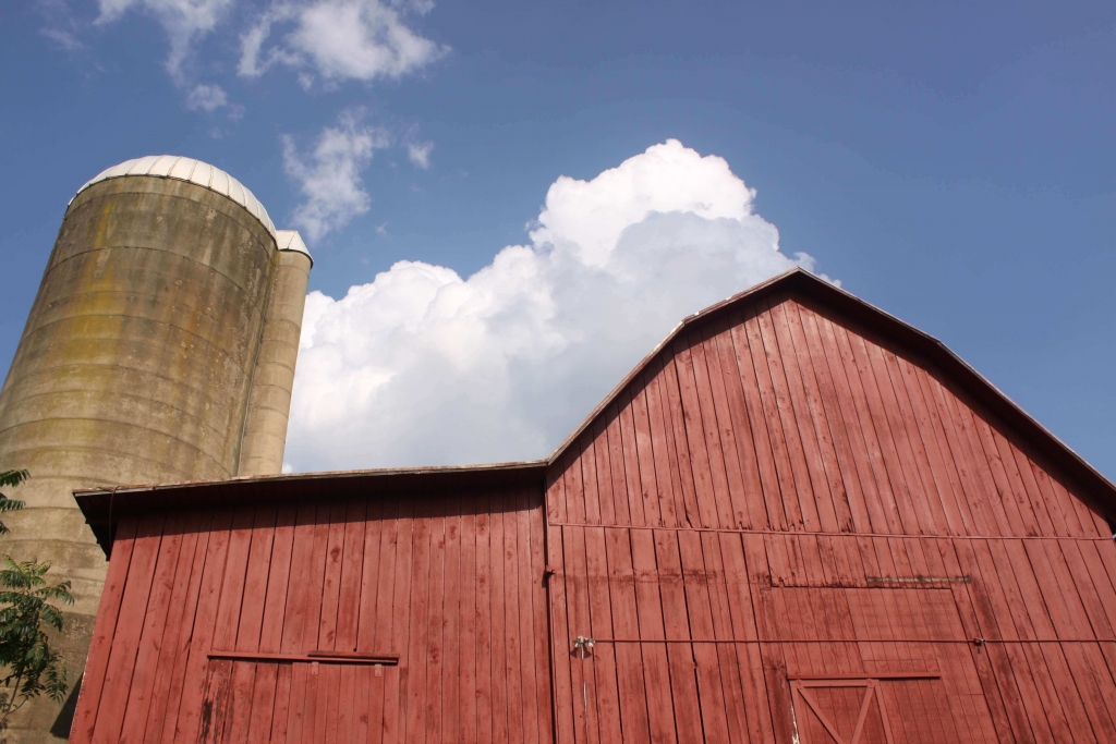 Red barn, blue sky, and white clouds