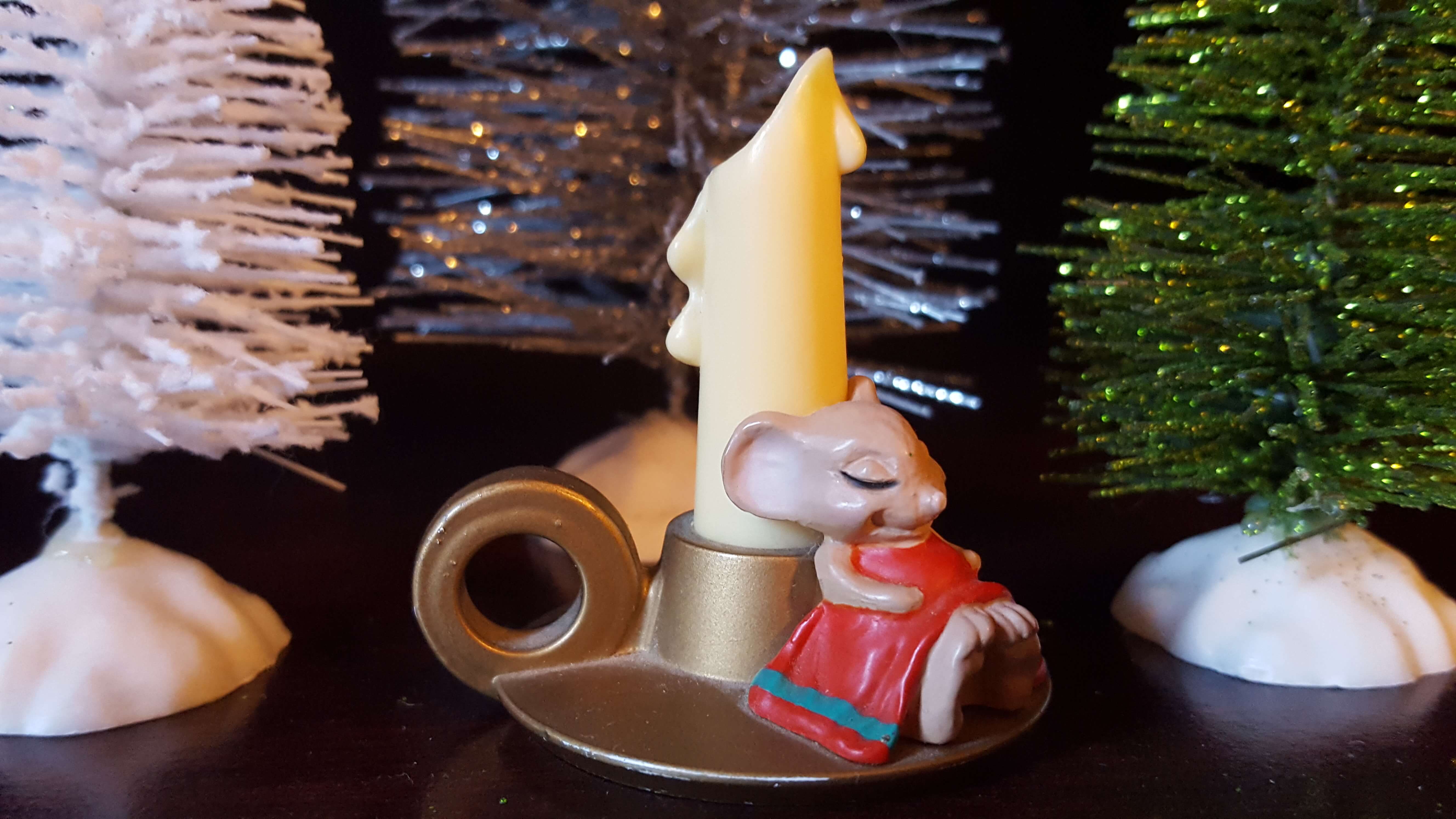 Little mouse sleeping near a candlestick